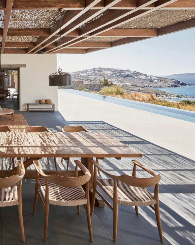 A view of the ocean from the open air dining room of Villa Mandra: A Summer Home In Mykonos, Greece.