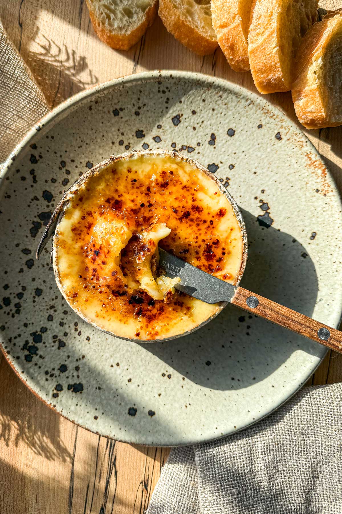 Maple brûlée Harbison recipe with molten Vermont cheese and caramelized maple sugar crust