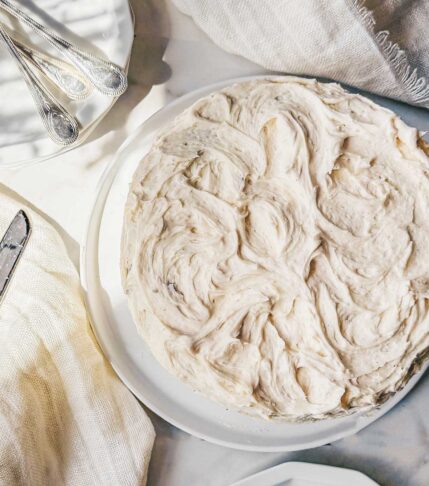 A carrot cake frosted with brown butter cream cheese frosting