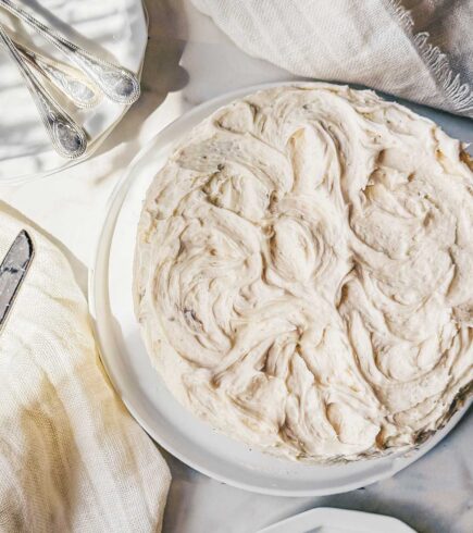 A carrot cake frosted with brown butter cream cheese frosting