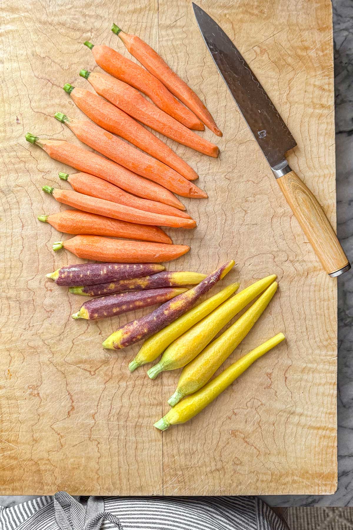 Carrots before blanching showing dull color on a cutting board