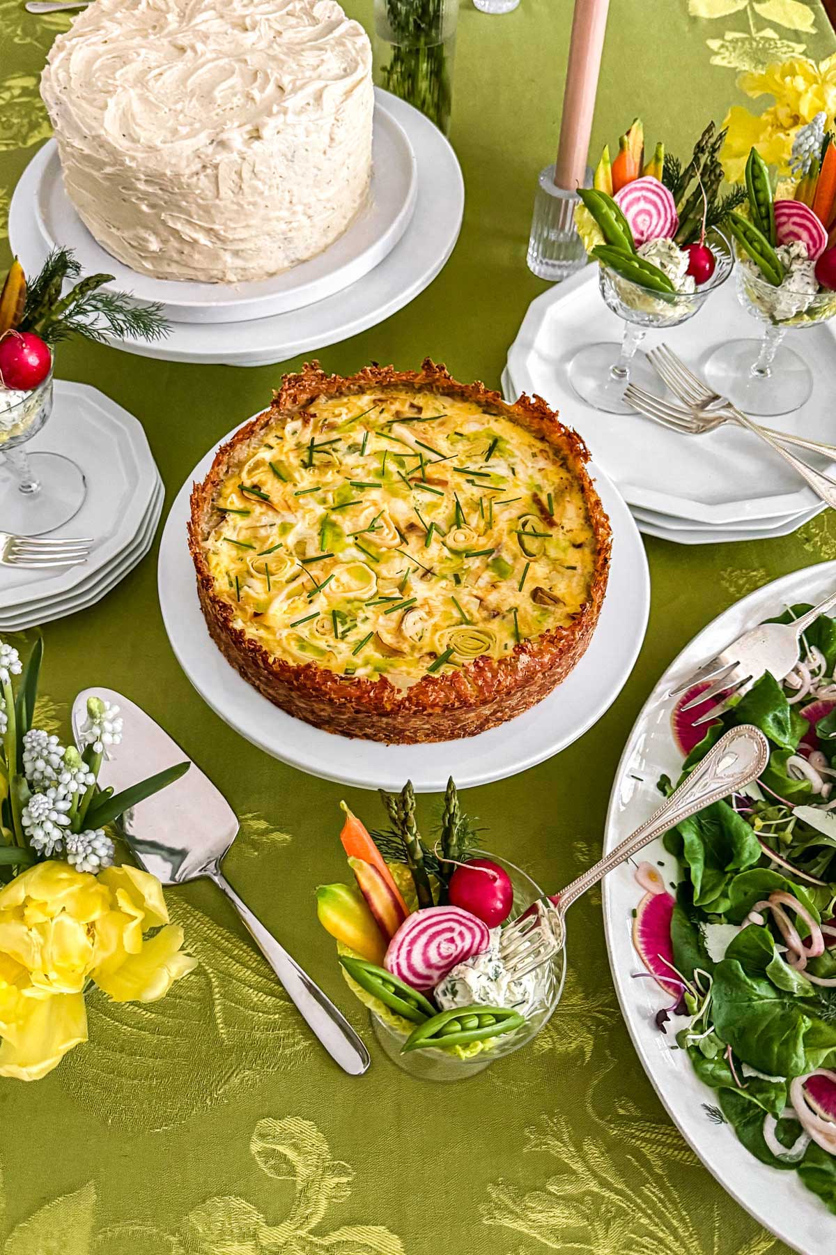 Early spring greens salad with butter lettuce, watermelon radishes, shaved parmesan, and pickled shallots being served on the table at a spring brunch.