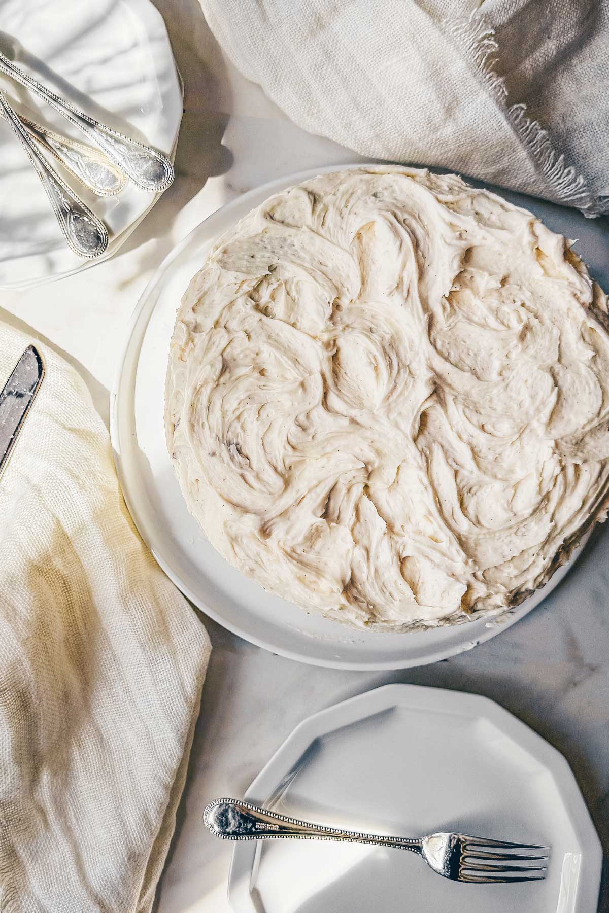 A carrot cake frosted with brown butter cream cheese frosting