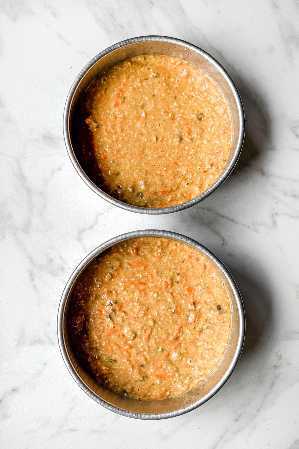 Two pans with batter for carrot cake